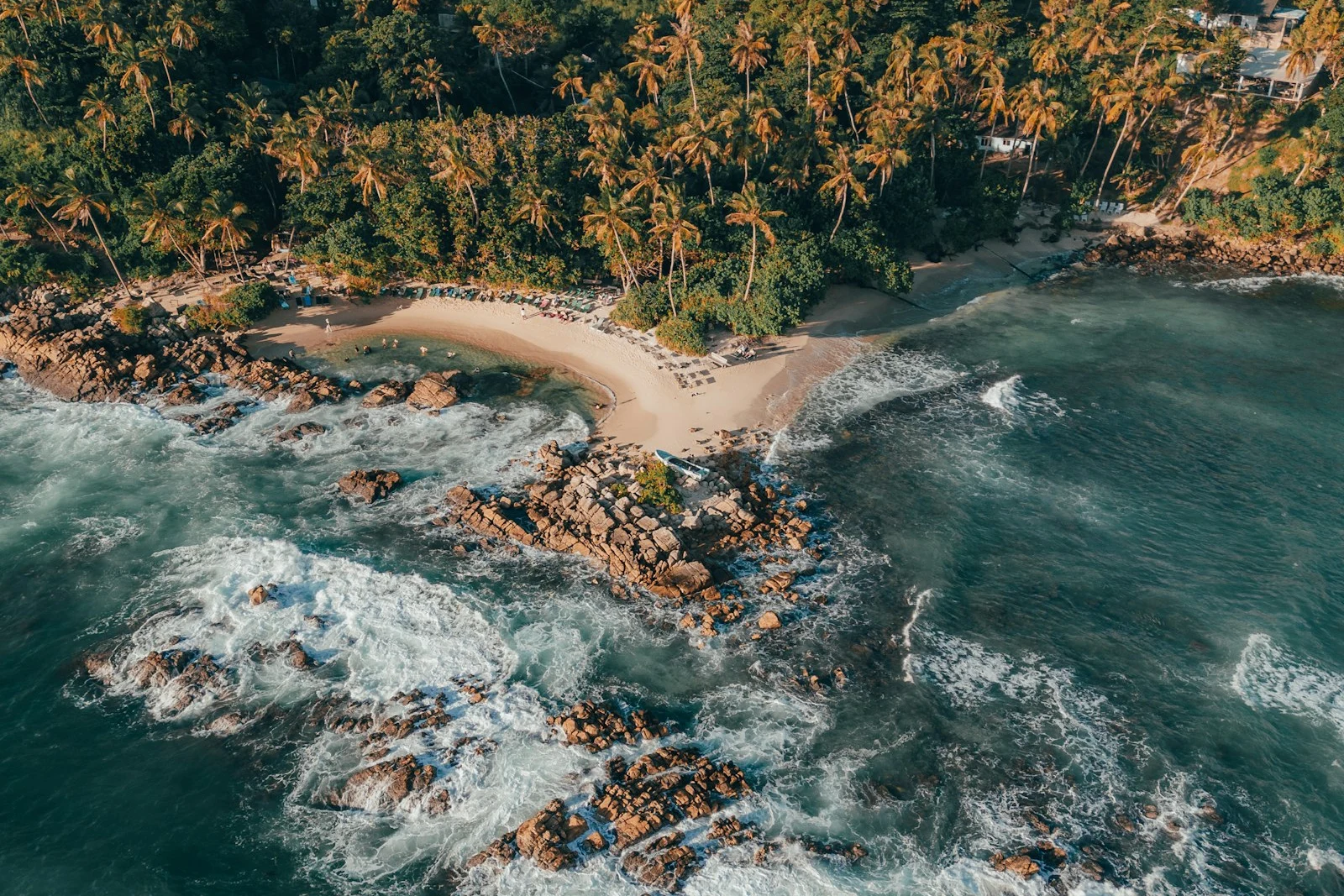 Aerial view of a palm-lined beach and turquoise sea in Sri Lanka