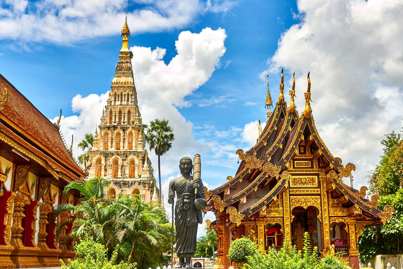 Ornate Thai temple architecture under a bright blue sky